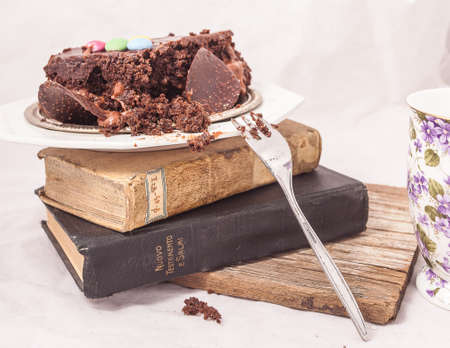 Slices of chocolate cake with strawberries. blueberries, cream ganache, hazelnut cream, nuts,...