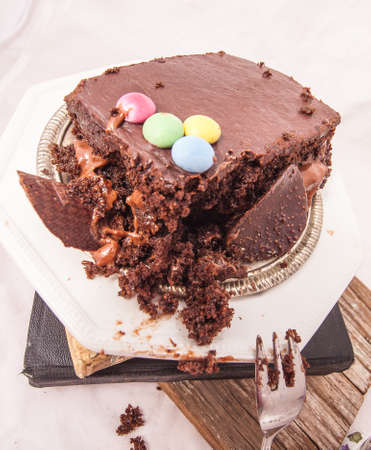 Slices of chocolate cake with strawberries. blueberries, cream ganache, hazelnut cream, nuts, cookies.の写真素材