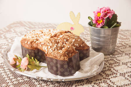Easter dove on a board with lace tablecloth and a jar with primroses.の写真素材