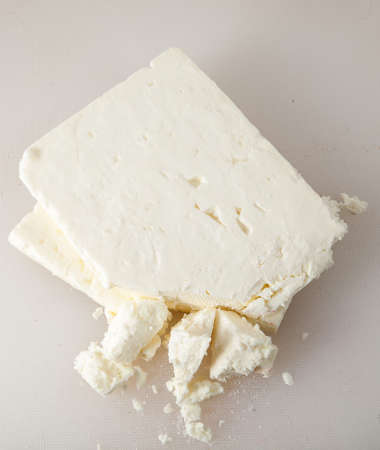 Black feta cheese in studio on white background.の写真素材