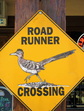 Road runner crossing sign in Death Valley National Park, Californiaの写真素材
