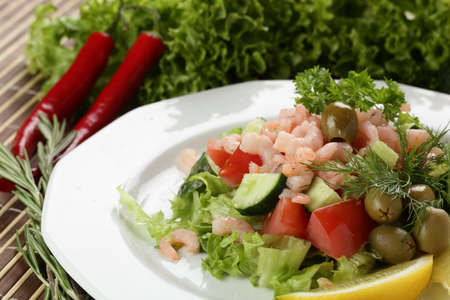 cold and fresh salad on white dishの写真素材