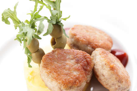 cold cutlets with garnish on white background