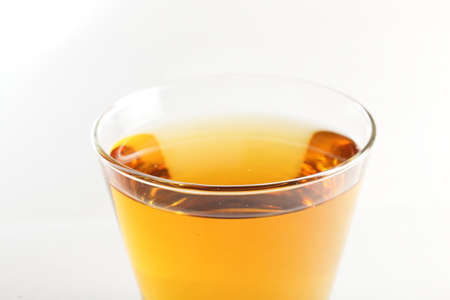 cold and fresh juice on cup and white backgroundの写真素材