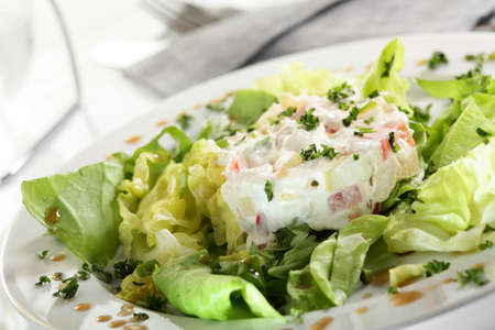 fresh and tasty european salad on white dishの写真素材
