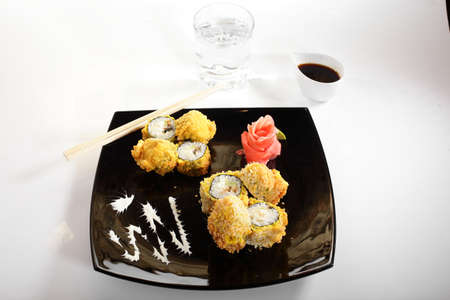 cold sushi on black dish and white backgroundの写真素材