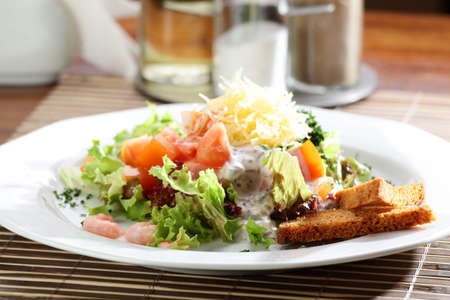 Fresh and tasty salad on the wooden tableの写真素材