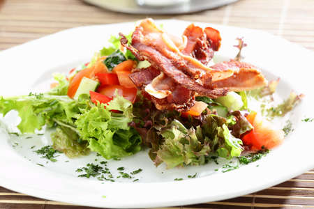 Fresh and tasty salad on the wooden tableの写真素材
