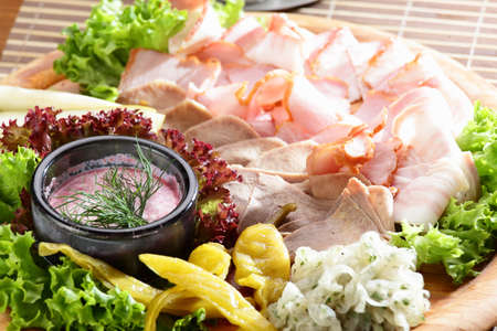 Fresh cold cuts on the wooden plateの写真素材