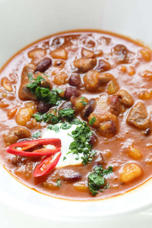Hot soup in the white dish on wooden tableの写真素材