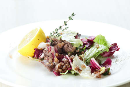 Fresh and tasty salad in white dishの写真素材