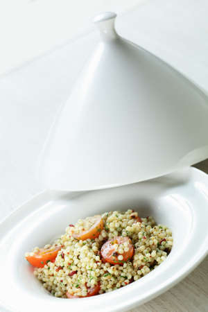 Millet in the white dish on wooden tableの写真素材
