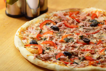 tasty and hot pizza with pepper and olivesの写真素材