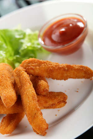 hot roasted potato sticks with salad and sauceの写真素材