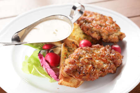 fresh and tasty peaces of meat with garnishの写真素材