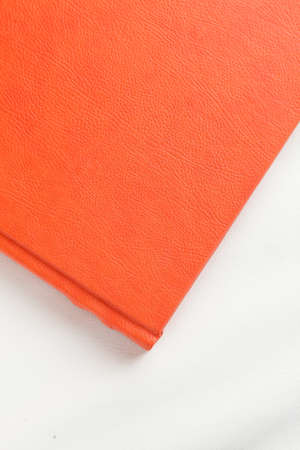orange leather book on bright backgroundの写真素材