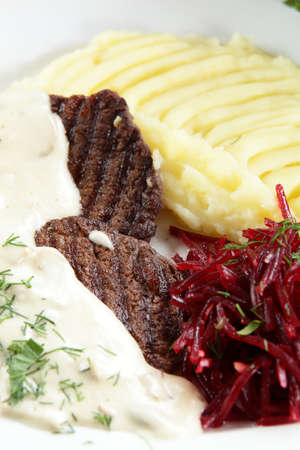 fresh and tasty peaces of meat with garnishの写真素材