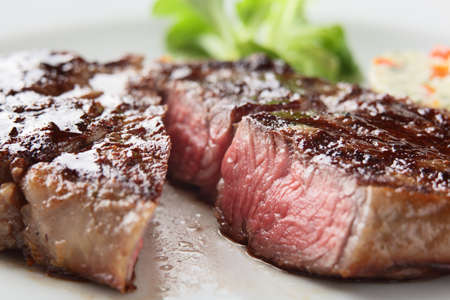 fresh and tasty peaces of meat with garnishの写真素材