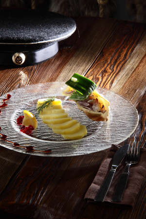 hot and tasty peaces of potato on transparent dishの写真素材
