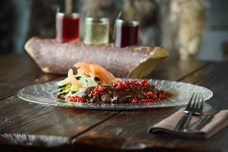 fresh and tasty peaces of meat with garnishの写真素材