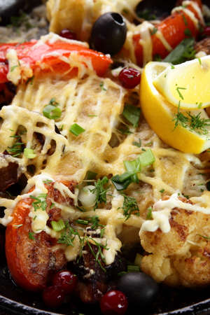 roasted meat with pepper on black pan