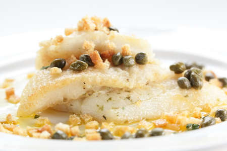 roasted peaces of fish with garnish on white backgroundの写真素材