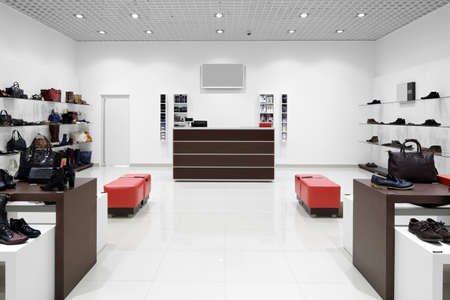 bright and fashionable interior of shoe store in modern mall