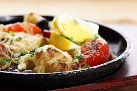 roasted meat with pepper on black panの写真素材