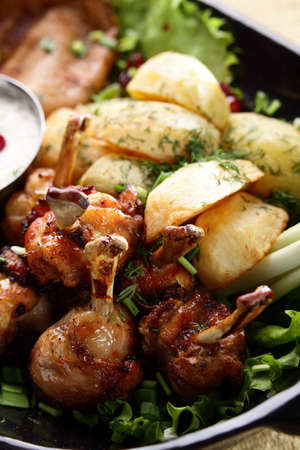 roasted chicken legs with sauce and berriesの写真素材