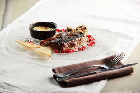 close up of fried salmon with cranberries and sauceの写真素材