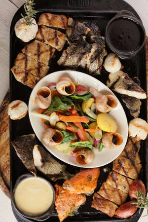plate of grilled fish on bright background