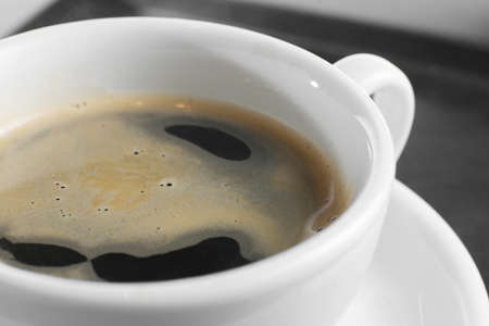 hot and fresh coffee in a cup on white background