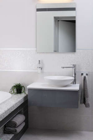 bright and modern bathroom with chrome tapの写真素材