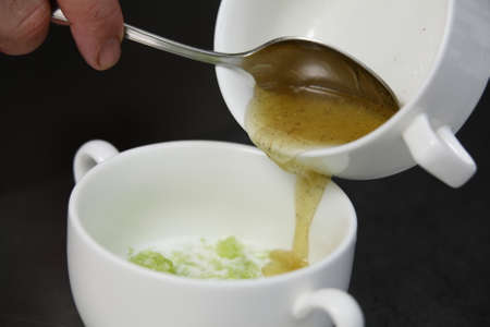 preparing green organic creamy soup in modern restaurantの写真素材