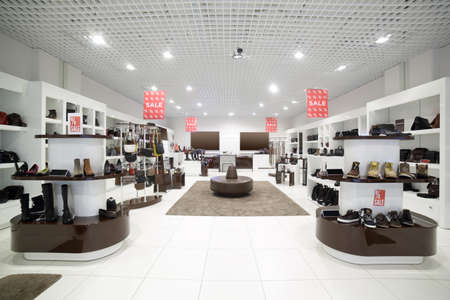 bright and fashionable interior of shoe store in modern mall