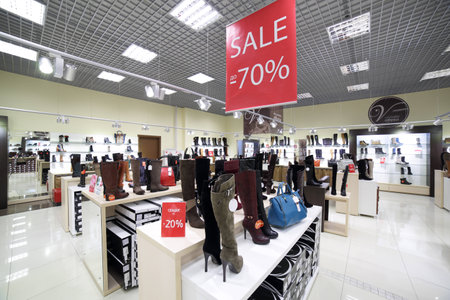 bright and fashionable interior of shoe store in modern mall