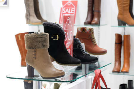 bright and fashionable interior of shoe store in modern mallの写真素材