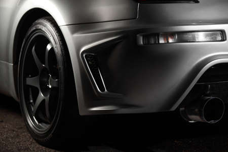 close up of grey car wheel on asphalt