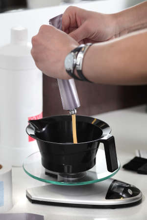 paint mixing on bright background in beauty salonの写真素材