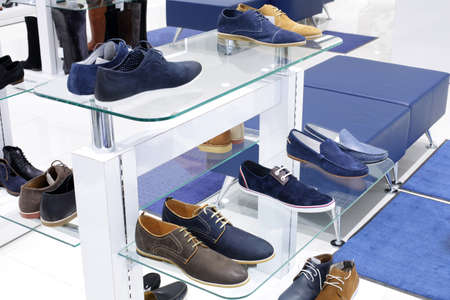 bright and fashionable interior of shoe store in modern mallの写真素材