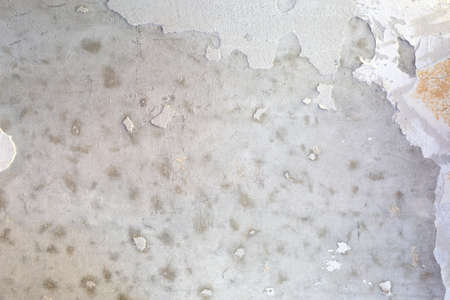 Grunge texture. Stained concrete and plaster and a piece of wallpaper.の写真素材