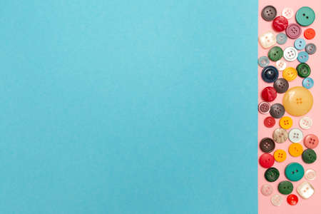 Buttons for clothes on a colored background. Place for your text. Advertising banner. Clipboard mockup. Copy space.の写真素材
