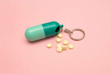 Travel pill box. Pill shape. The use of tablets in doses. Keep your health. Lots of yellow pills on...