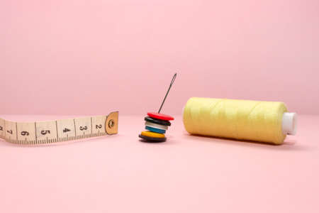 Sewing accessories threads, tape measure, needles, and buttons for clothes. Sewing...