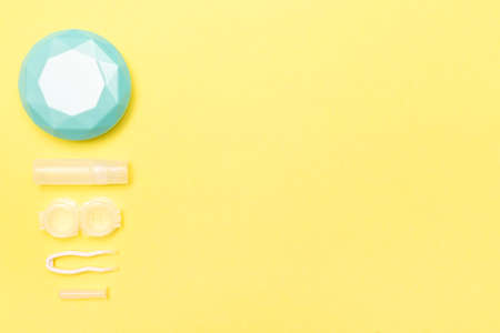Travel kit for contact lenses. Yellow background. Care and hygiene. Keep your health. Copy space. Place for text.の写真素材
