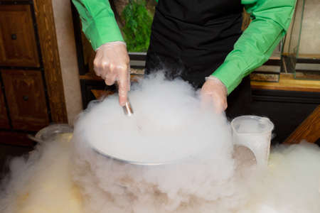 Making ice cream with liquid nitrogen. Show program of the chef for the holiday. Steam from a chemical reaction.の写真素材