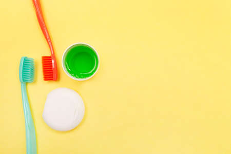 Teeth hygiene and oral dental care products. Morning concept. Yellow background. Oral Care Set. Copy space. Mockup.の写真素材