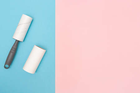 The cleaning roller. Sticky Lint Roller Set. Blue and pink background. Copy space. Place for text. Top view.の写真素材