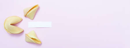 Banner with fortune cookie on a pink background and place for text. mockup. Blank paper for writing...