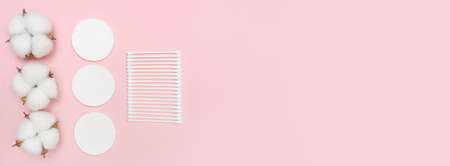 Banner with cotton flowers, cotton buds, and makeup discs. Blog about beauty. Place for text. Copy space. Pink background. Beauty saloon. Flay lay. Top view.の写真素材